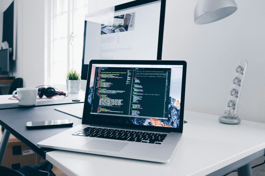 A laptop with microsegmentation code on the screen sitting on a white desk in a bright office