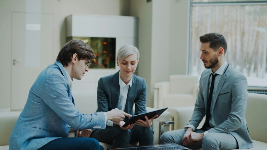 Three colleagues sit and collaborate on Microsoft 365 Cybersecurity