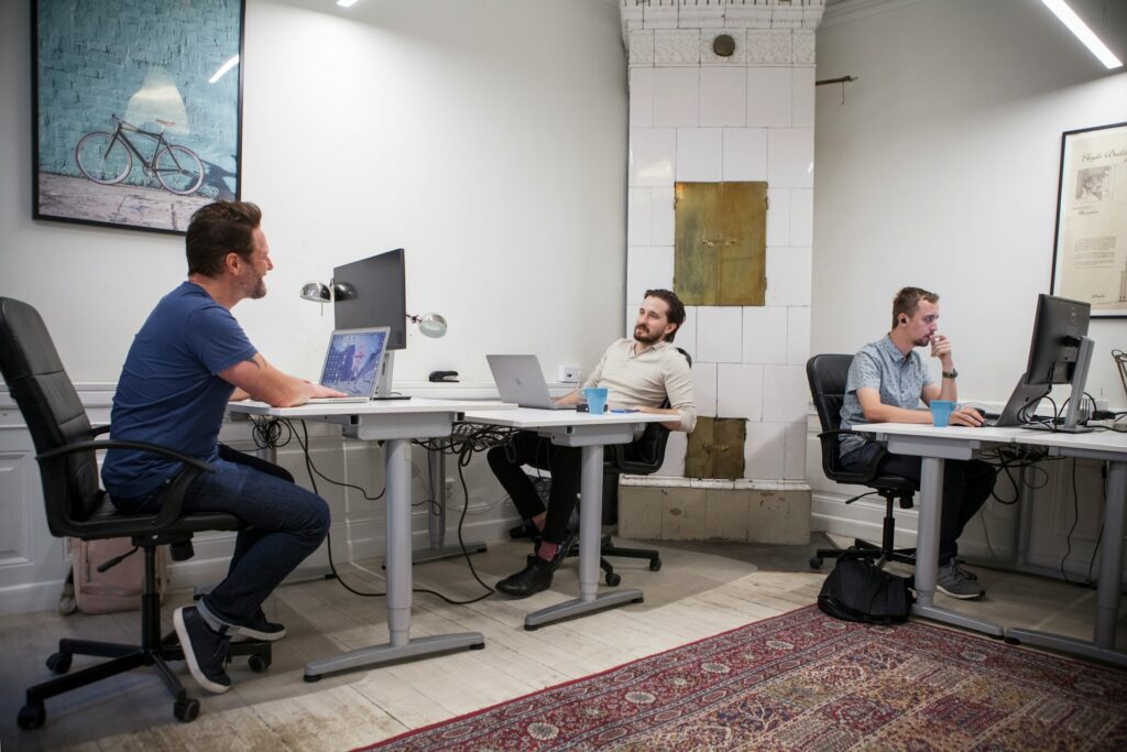 Colleagues work together on infrastructure modernization in an open office.