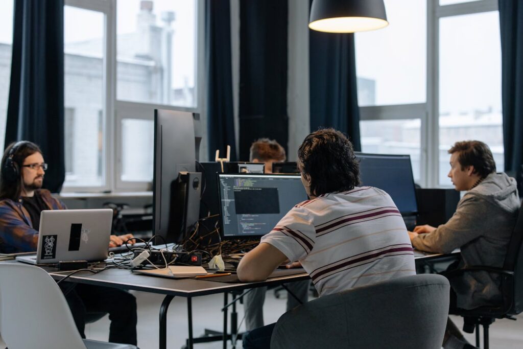 Team members working on AI-driven DevSecOps at computers in an operations center