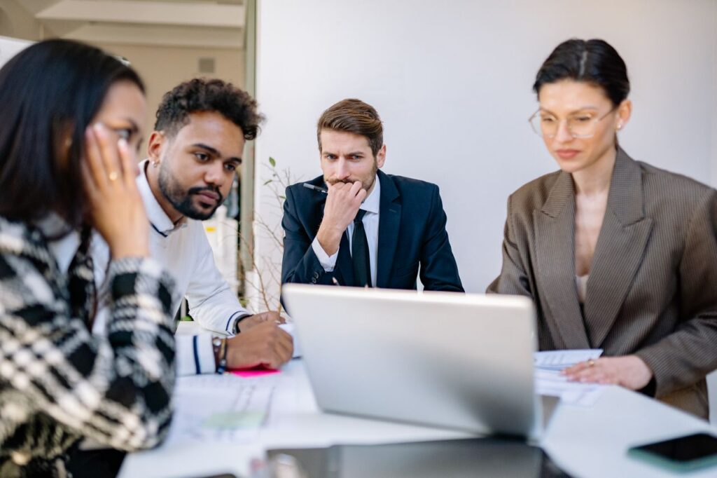 An investment firm's security team looks inward at a laptop to check on its AI model security status.