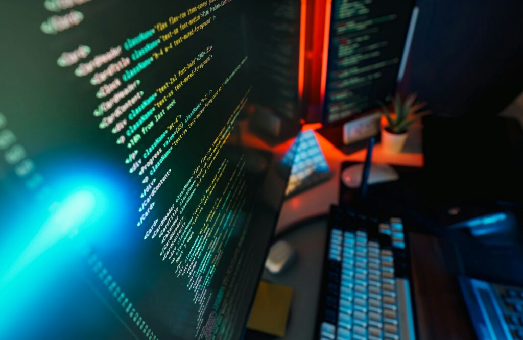 cybersecurity code on a black computer screen in a dark cyber threat ops center