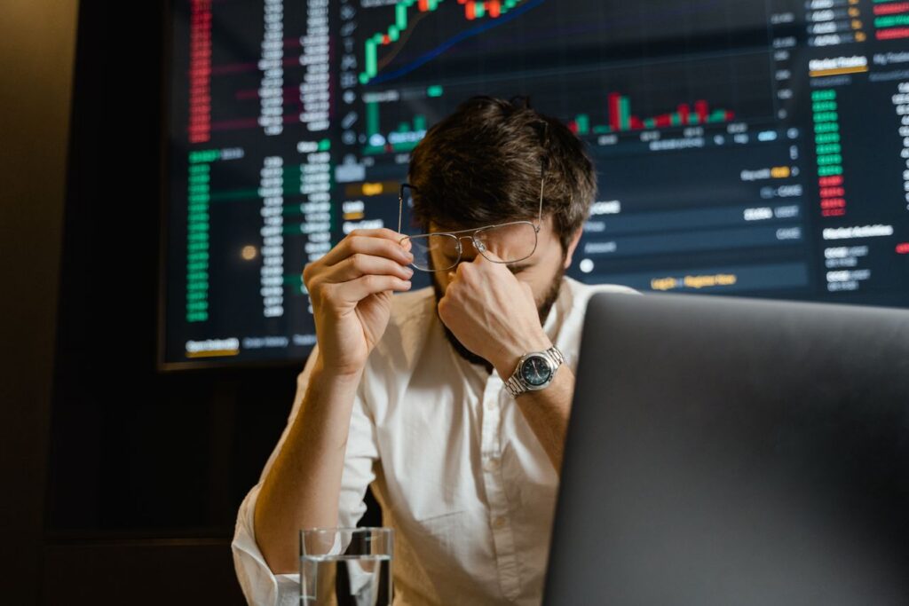 Investment leader stressing about data fragmentation while looking at financial charts